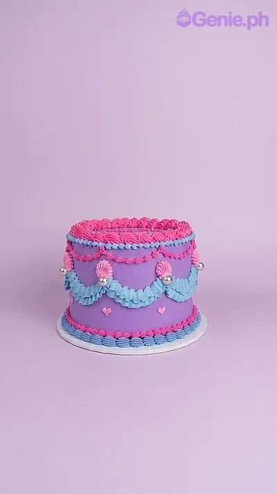 A purple, pink, and blue 1-tier cake themed Kpop Demon Hunters, with icing swags, silver pearls, and ruffled borders. A purple, pink, and blue 1-tier cake themed Kpop Demon Hunters, with icing swags, silver pearls, and ruffled borders.
