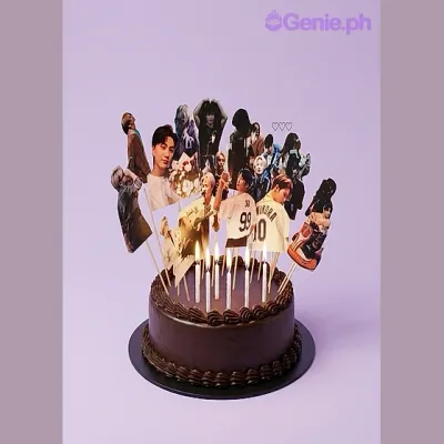 Chocolate 1-tier cake with multiple K-pop photo printouts on sticks and lit candles Chocolate 1-tier cake with multiple K-pop photo printouts on sticks and lit candles