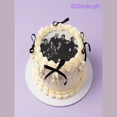 White 1-tier cake with a group photo printout on top and black satin ribbon accents White 1-tier cake with a group photo printout on top and black satin ribbon accents