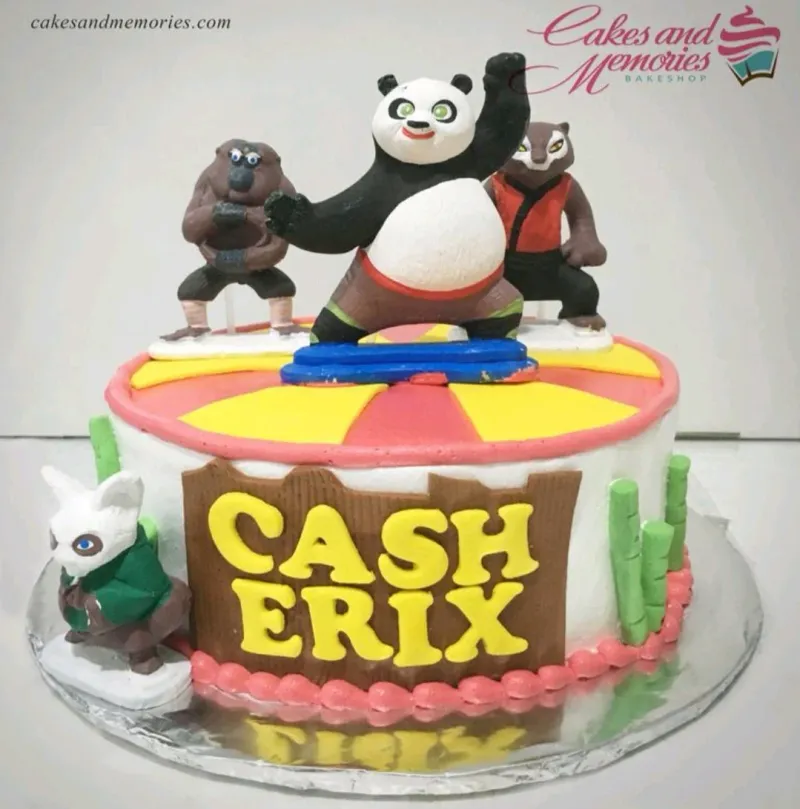 A multicolor 1-tier Kung Fu Panda cake, featuring Po, Shifu, and Monkey figurines, with a striped top. A multicolor 1-tier Kung Fu Panda cake, featuring Po, Shifu, and Monkey figurines, with a striped top.