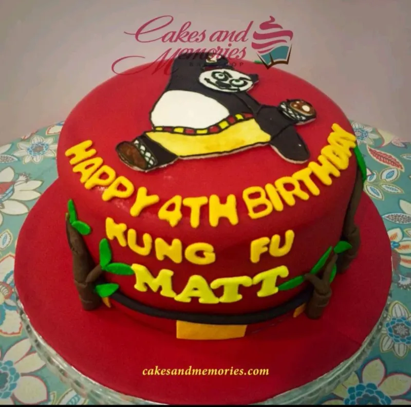A red 1 Tier Fondant cake themed around Kung Fu Panda, featuring a flat Po character, yellow letters, and bamboo accents. A red 1 Tier Fondant cake themed around Kung Fu Panda, featuring a flat Po character, yellow letters, and bamboo accents.