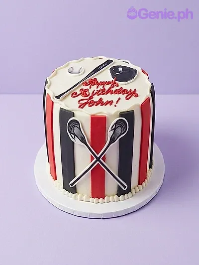 A white 1-tier cake themed around Lacrosse Sports, with red and black vertical stripes and lacrosse stick printouts. A white 1-tier cake themed around Lacrosse Sports, with red and black vertical stripes and lacrosse stick printouts.