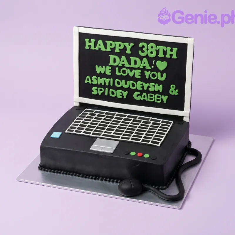 A black laptop-shaped fondant cake with a green message on the screen and a white piped keyboard design. A black laptop-shaped fondant cake with a green message on the screen and a white piped keyboard design.