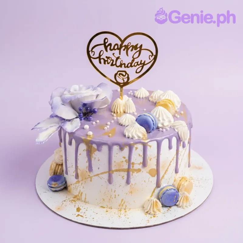 A lavender, white, and gold 1-tier cake with a gold drip, featuring a 'Happy Birthday' topper and an edible rose. A lavender, white, and gold 1-tier cake with a gold drip, featuring a 'Happy Birthday' topper and an edible rose.