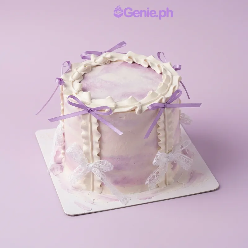 Lavender and white marbled 1-tier cake with soft icing, vertical piped ruffles, and decorative purple satin and white lace bows Lavender and white marbled 1-tier cake with soft icing, vertical piped ruffles, and decorative purple satin and white lace bows