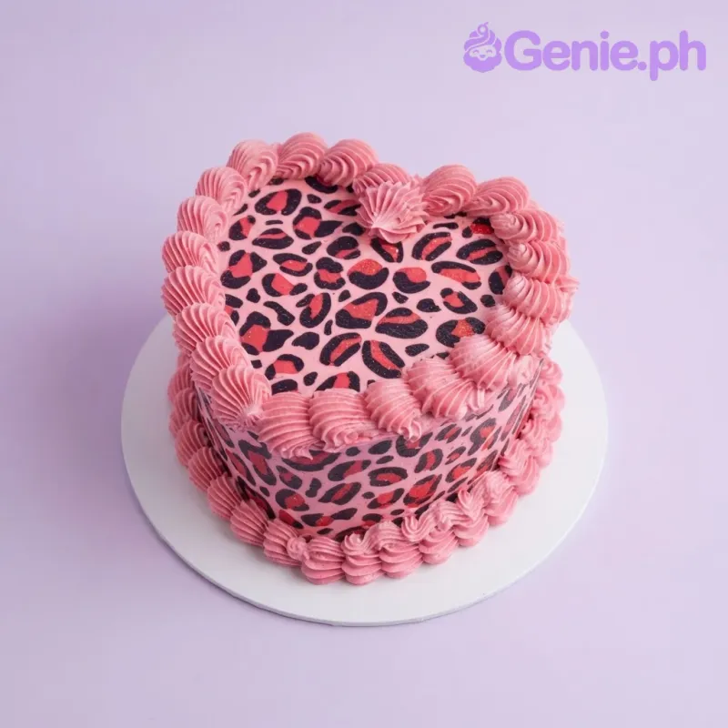 Pink heart cake with smooth soft icing, leopard print pattern, and piped pink shell borders Pink heart cake with smooth soft icing, leopard print pattern, and piped pink shell borders