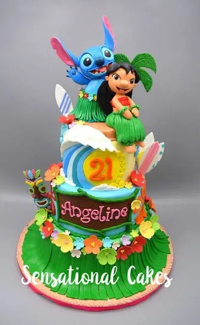 A 3-tier Lilo and Stitch fondant cake with tropical flowers, a grass skirt base, and character toppers A 3-tier Lilo and Stitch fondant cake with tropical flowers, a grass skirt base, and character toppers