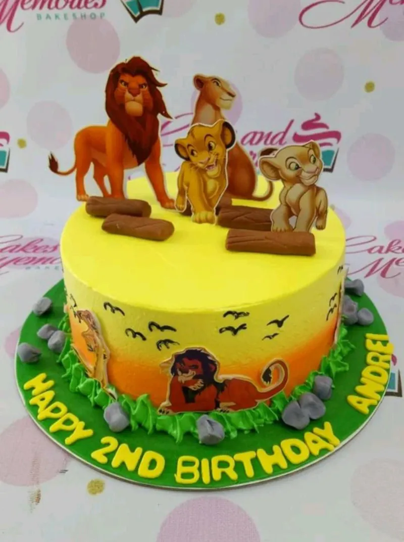 A yellow and orange 1 Tier cake themed around Lion King, featuring Simba, Nala, and Scar printout toppers, and green icing grass. A yellow and orange 1 Tier cake themed around Lion King, featuring Simba, Nala, and Scar printout toppers, and green icing grass.