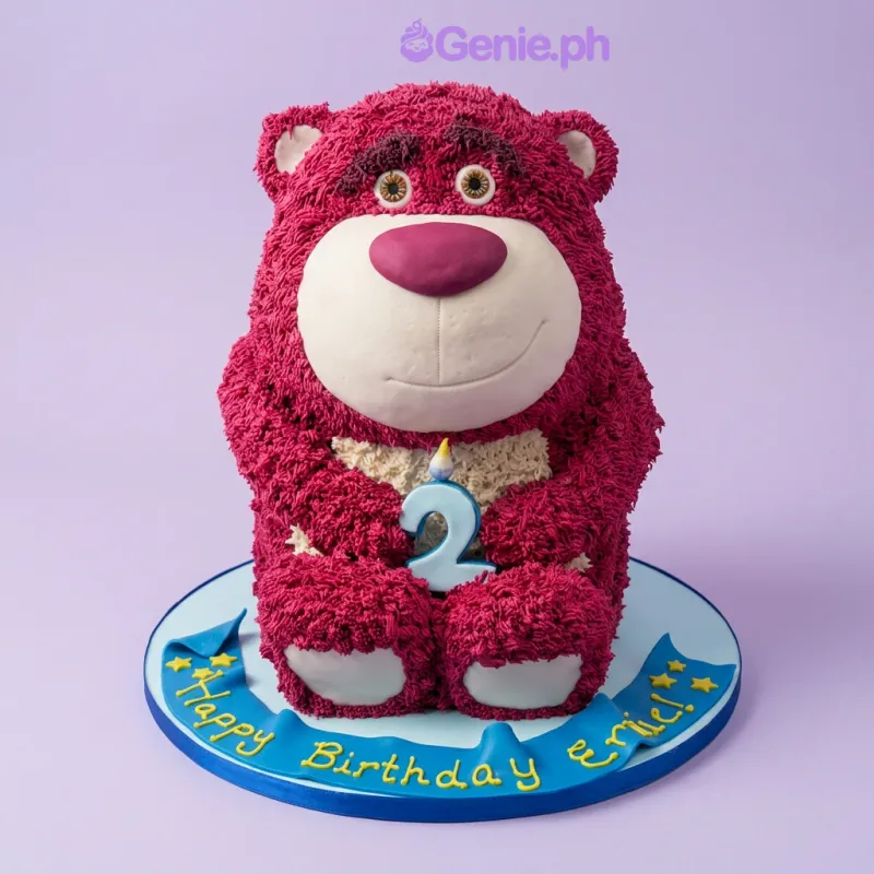 Pink bear-shaped birthday cake with a number 2 candle and blue banner on the base board Pink bear-shaped birthday cake with a number 2 candle and blue banner on the base board