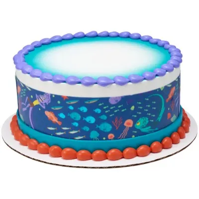 A blue gradient 1-tier cake themed Luca Underwater, featuring printed side wrap, purple rosettes, and orange dollops. A blue gradient 1-tier cake themed Luca Underwater, featuring printed side wrap, purple rosettes, and orange dollops.