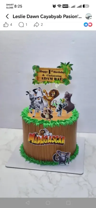 Tan and brown 1-tier cake with soft icing, Madagascar theme, and printed character cutouts Tan and brown 1-tier cake with soft icing, Madagascar theme, and printed character cutouts