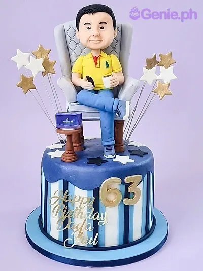 Blue and white striped fondant cake with a 3D man figurine sitting in a chair holding a coffee cup and phone. Blue and white striped fondant cake with a 3D man figurine sitting in a chair holding a coffee cup and phone.