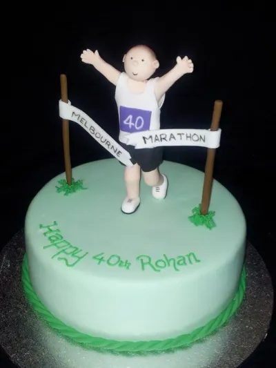 Mint green 1-tier fondant cake with a marathon runner figurine, a finish line banner, and green piped message Mint green 1-tier fondant cake with a marathon runner figurine, a finish line banner, and green piped message