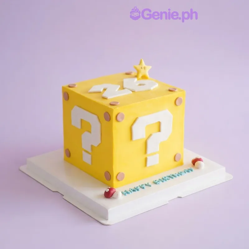 Yellow square cake with white question mark panels, a number 26 topper, and red mushroom accents on the base board Yellow square cake with white question mark panels, a number 26 topper, and red mushroom accents on the base board