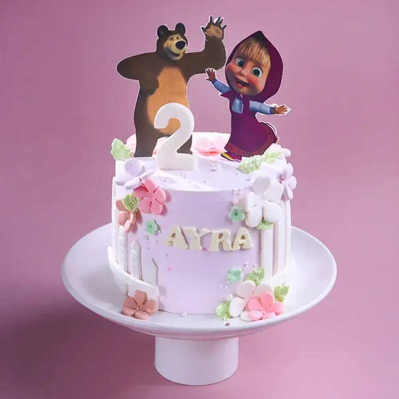 Light pink 1-tier cake with Masha and the Bear printouts, fondant flowers, and a number 2 candle Light pink 1-tier cake with Masha and the Bear printouts, fondant flowers, and a number 2 candle