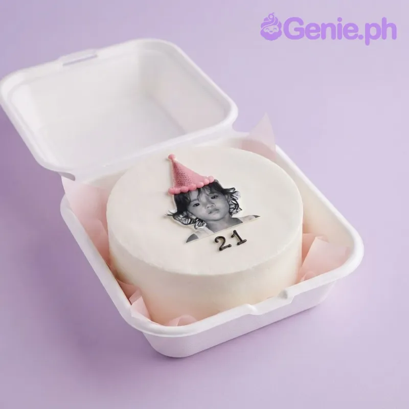 White bento cake with smooth soft icing, a portrait with party hat topper, and a piped message White bento cake with smooth soft icing, a portrait with party hat topper, and a piped message