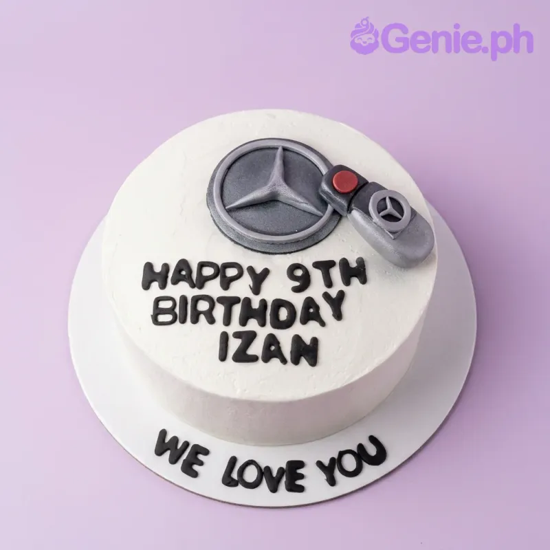 White minimalist Mercedes-Benz themed birthday cake with a 3D fondant car key and logo topper. White minimalist Mercedes-Benz themed birthday cake with a 3D fondant car key and logo topper.