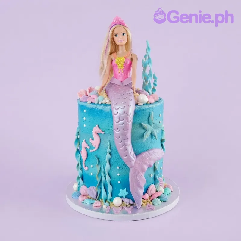 Sky blue 1-tier birthday cake with smooth soft icing, a mermaid doll topper, and sugar seashells Sky blue 1-tier birthday cake with smooth soft icing, a mermaid doll topper, and sugar seashells
