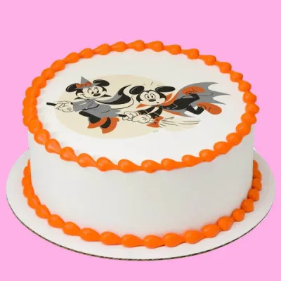 A white and orange 1 Tier round cake themed around Mickey Halloween, featuring a Mickey and Minnie Mouse printout and orange piped borders. A white and orange 1 Tier round cake themed around Mickey Halloween, featuring a Mickey and Minnie Mouse printout and orange piped borders.
