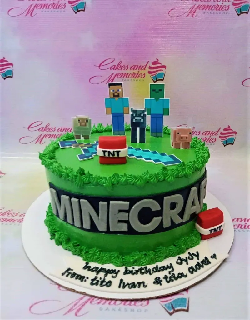 A green and white 1-tier cake themed around Minecraft, featuring character printouts, TNT blocks, and green grass-like icing borders. A green and white 1-tier cake themed around Minecraft, featuring character printouts, TNT blocks, and green grass-like icing borders.