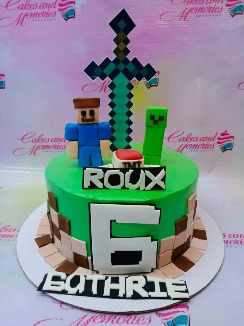A green and white 1 Tier cake themed around Minecraft, featuring Steve, Creeper, diamond sword, number 6, dirt blocks, TNT. A green and white 1 Tier cake themed around Minecraft, featuring Steve, Creeper, diamond sword, number 6, dirt blocks, TNT.