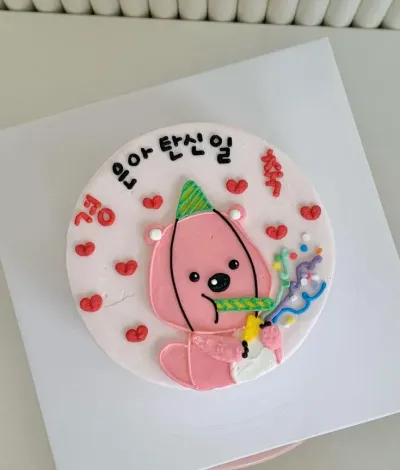 Light pink bento cake with smooth soft icing, a pink bear character topper, and red fondant heart accents Light pink bento cake with smooth soft icing, a pink bear character topper, and red fondant heart accents