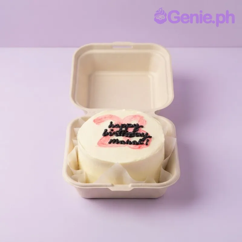 White bento cake with soft icing finish and red and black piped birthday script on top White bento cake with soft icing finish and red and black piped birthday script on top