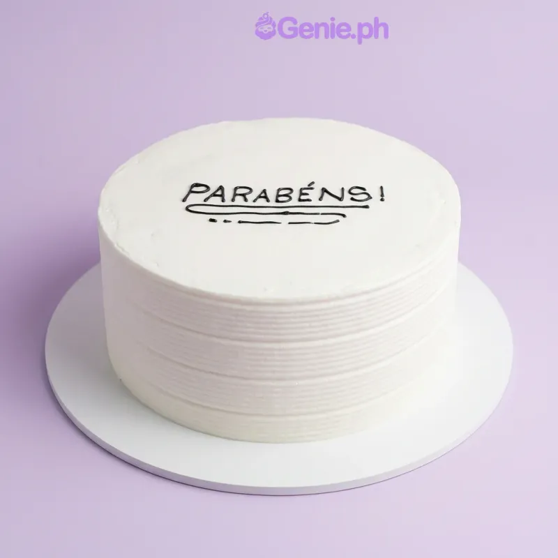 A single tier white soft-iced cake with black icing text and a piped logo on the board A single tier white soft-iced cake with black icing text and a piped logo on the board