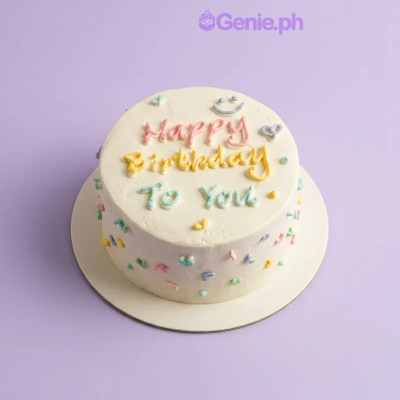 White 1-tier birthday cake with piped Happy Birthday message and colorful icing hearts and smiley face White 1-tier birthday cake with piped Happy Birthday message and colorful icing hearts and smiley face