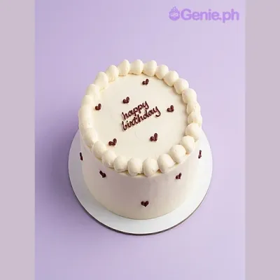 White bento birthday cake with brown piped Happy Birthday message and small brown heart decorations White bento birthday cake with brown piped Happy Birthday message and small brown heart decorations