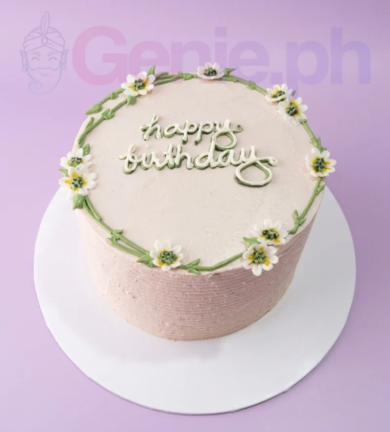 A light pink and green 1 Tier cake themed Minimalist Floral, with a green vine border, white edible flowers, and 'happy birthday' text. A light pink and green 1 Tier cake themed Minimalist Floral, with a green vine border, white edible flowers, and 'happy birthday' text.