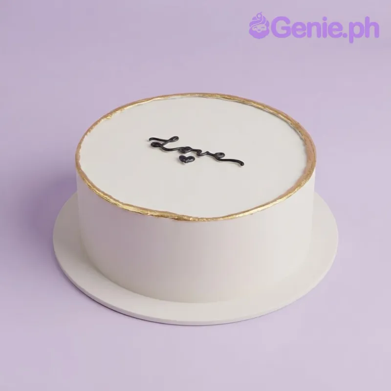 Crisp white 1 tier fondant cake with smooth icing, minimalist love theme, gold top rim border, and a black piped message Crisp white 1 tier fondant cake with smooth icing, minimalist love theme, gold top rim border, and a black piped message