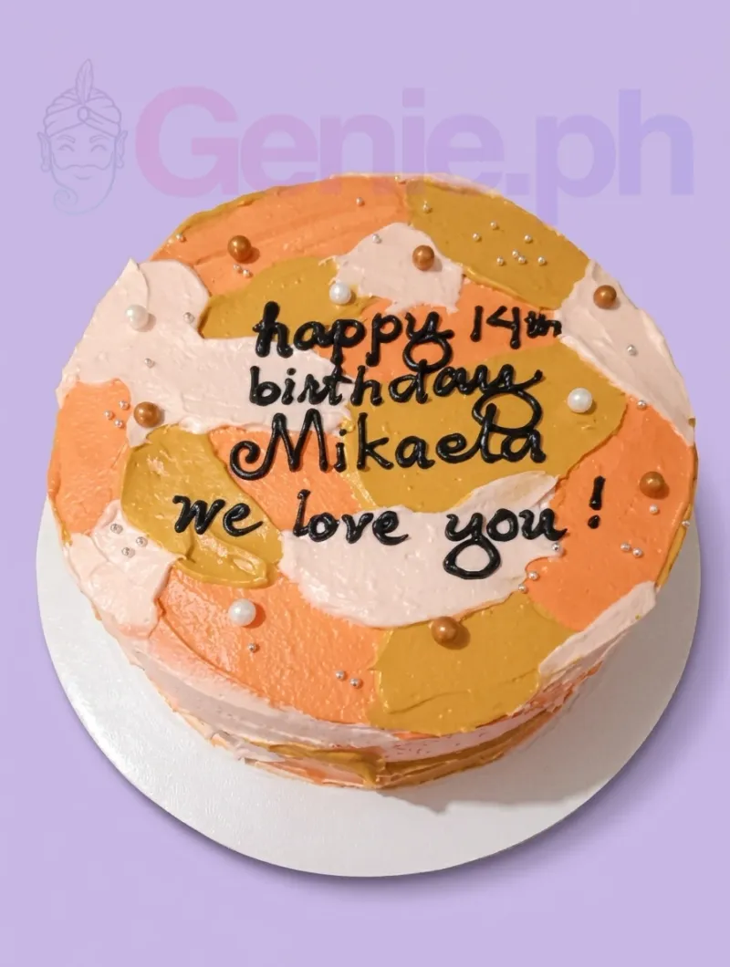 A white, orange, yellow 1-tier round cake with palette knife icing textures, featuring gold and white pearls and black piped text. A white, orange, yellow 1-tier round cake with palette knife icing textures, featuring gold and white pearls and black piped text.