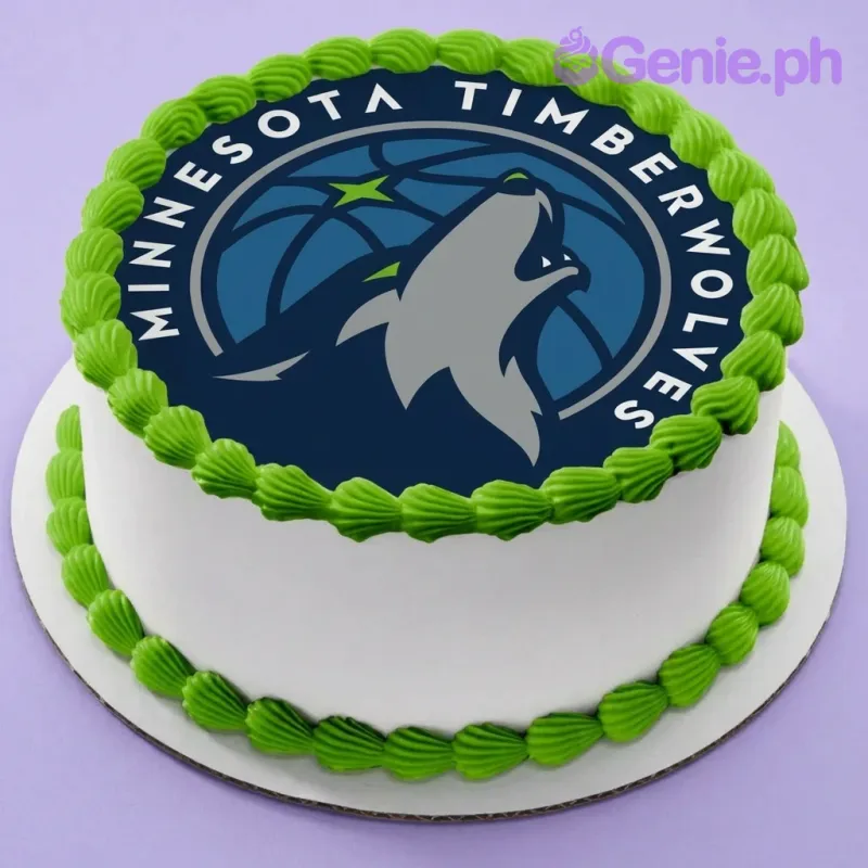 A white and green round 1-tier cake themed around Minnesota Timberwolves, featuring a large Minnesota Timberwolves logo printout and green icing borders. A white and green round 1-tier cake themed around Minnesota Timberwolves, featuring a large Minnesota Timberwolves logo printout and green icing borders.