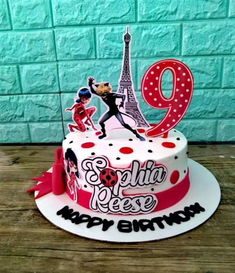 A Miraculous Ladybug and Cat Noir 1-tier cake with Eiffel Tower, number nine, and red and black polka dots. A Miraculous Ladybug and Cat Noir 1-tier cake with Eiffel Tower, number nine, and red and black polka dots.