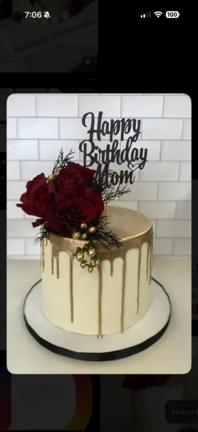 Elegant white cake with gold drip, dark red roses, and a black glittery Happy Birthday Mom topper. Elegant white cake with gold drip, dark red roses, and a black glittery Happy Birthday Mom topper.