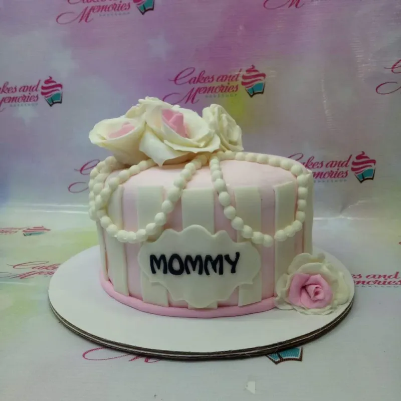 A pink and white striped 1 Tier Fondant cake for Mommy, with large white and pink sugar roses and edible pearl drapes. A pink and white striped 1 Tier Fondant cake for Mommy, with large white and pink sugar roses and edible pearl drapes.
