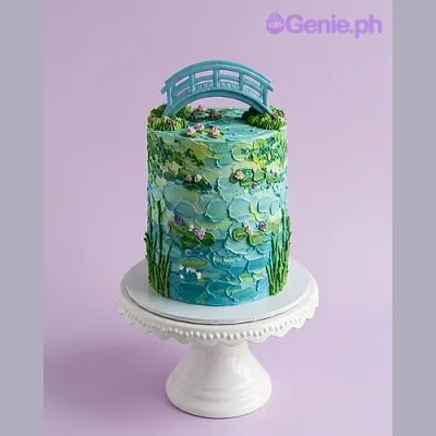 Blue 1-tier cake with impressionist painting style icing, pink water lilies, and a blue bridge topper Blue 1-tier cake with impressionist painting style icing, pink water lilies, and a blue bridge topper