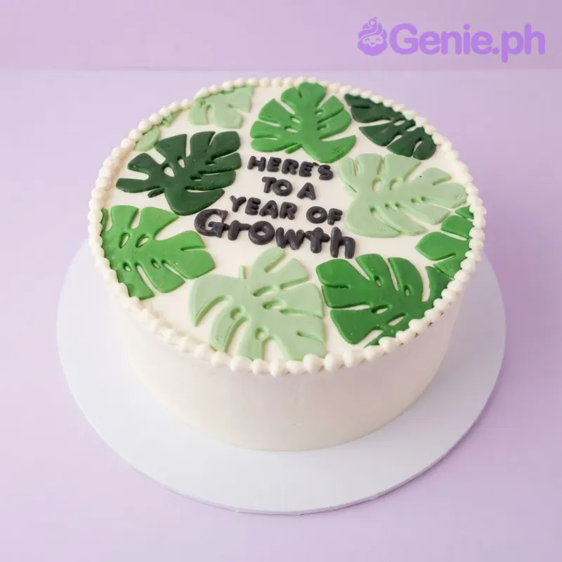White 1-tier cake with smooth soft icing, Monstera Growth theme, and green edible fondant leaves White 1-tier cake with smooth soft icing, Monstera Growth theme, and green edible fondant leaves