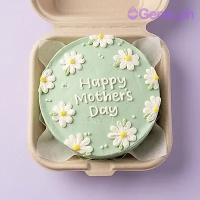 A light green, white, and yellow Bento cake themed around Mother's Day, featuring white daisy flowers and 'Happy Mother's Day' text. A light green, white, and yellow Bento cake themed around Mother's Day, featuring white daisy flowers and 'Happy Mother's Day' text.