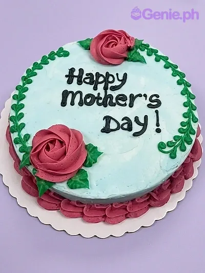A light blue 1-tier cake themed around Mother's Day, featuring pink icing roses, green leaf borders, and a black piped message. A light blue 1-tier cake themed around Mother's Day, featuring pink icing roses, green leaf borders, and a black piped message.