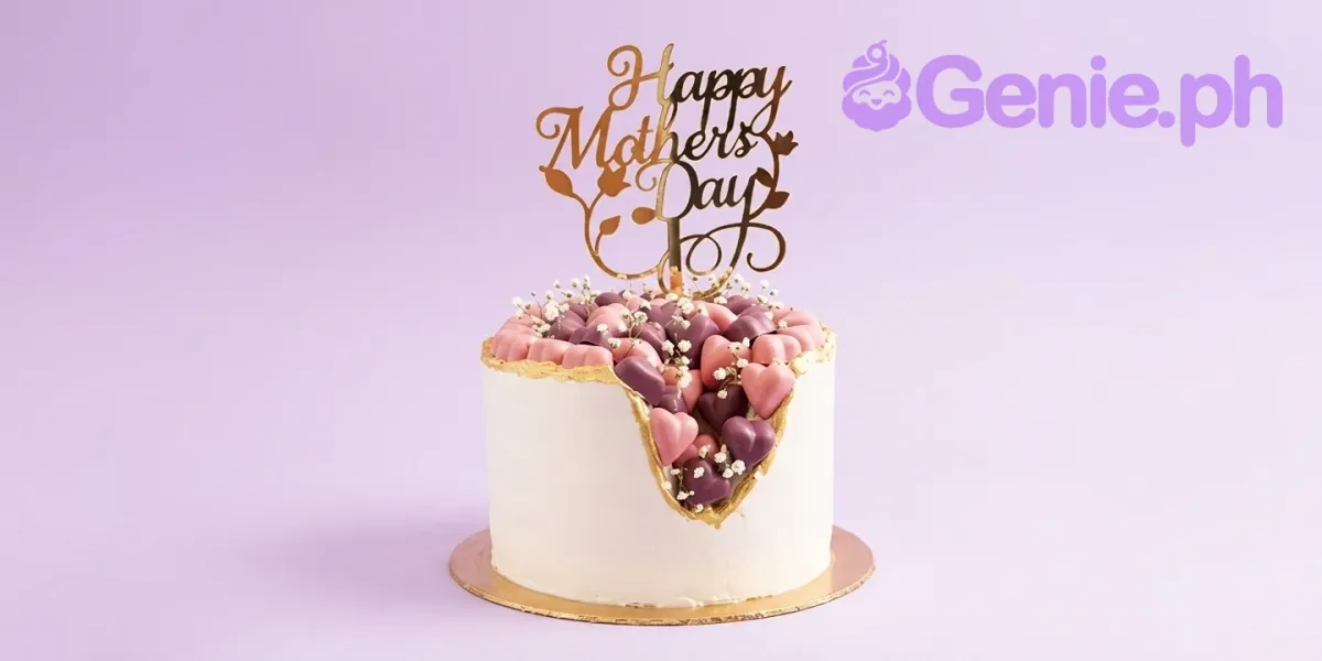 White 1-tier Mother's Day cake, gold topper, geode center, pink/purple hearts, baby's breath. White 1-tier Mother's Day cake, gold topper, geode center, pink/purple hearts, baby's breath.
