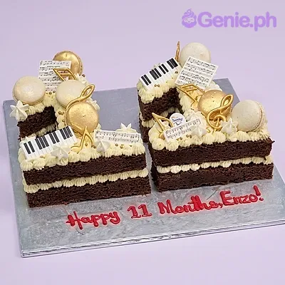 Chocolate number 11 cake with music-themed printouts, gold treble clefs, and macarons Chocolate number 11 cake with music-themed printouts, gold treble clefs, and macarons