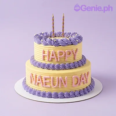 Light yellow 2-tier birthday cake with purple piped borders and pink piped message Light yellow 2-tier birthday cake with purple piped borders and pink piped message