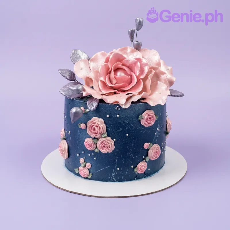 A navy blue 1-tier cake with a floral theme, featuring a large pink gumpaste rose, smaller roses, silver leaves, and white pearls. A navy blue 1-tier cake with a floral theme, featuring a large pink gumpaste rose, smaller roses, silver leaves, and white pearls.