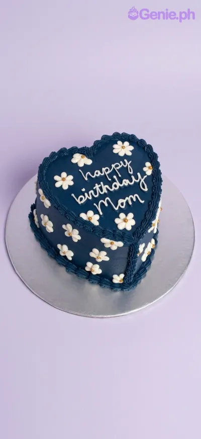 A navy blue and white 1-tier heart-shaped cake themed for Mom, featuring white icing daisies and 'Happy Birthday Mom' text. A navy blue and white 1-tier heart-shaped cake themed for Mom, featuring white icing daisies and 'Happy Birthday Mom' text.