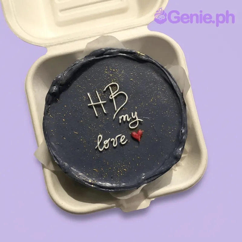 A navy blue bento cake themed Navy Minimalist, featuring a white "HB my love" message, a small red heart, and edible specks. A navy blue bento cake themed Navy Minimalist, featuring a white "HB my love" message, a small red heart, and edible specks.