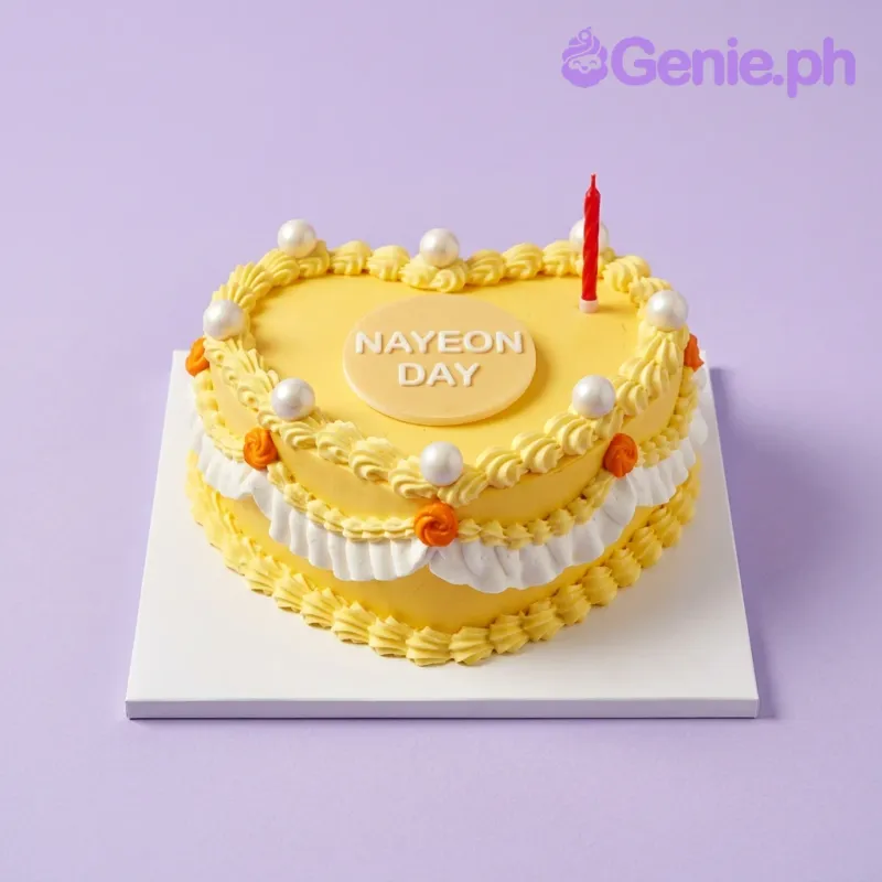 Yellow 1-tier birthday cake with white icing message and pearl decorations Yellow 1-tier birthday cake with white icing message and pearl decorations