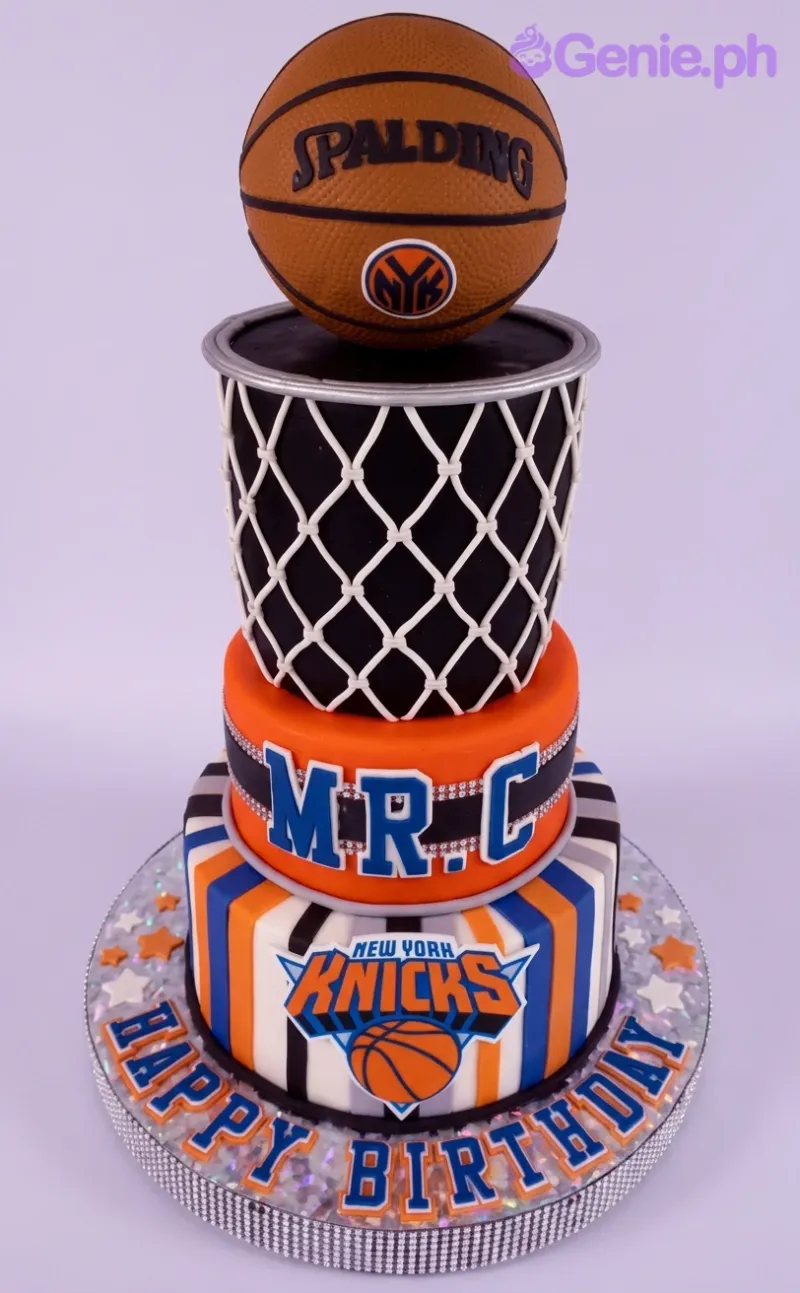 A multicolor 3-tier fondant New York Knicks Basketball cake with a Spalding basketball, Knicks logo, and net. A multicolor 3-tier fondant New York Knicks Basketball cake with a Spalding basketball, Knicks logo, and net.