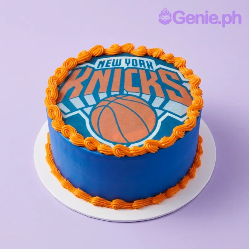 Blue single tier cake with orange piped borders and a New York Knicks logo edible print on top Blue single tier cake with orange piped borders and a New York Knicks logo edible print on top